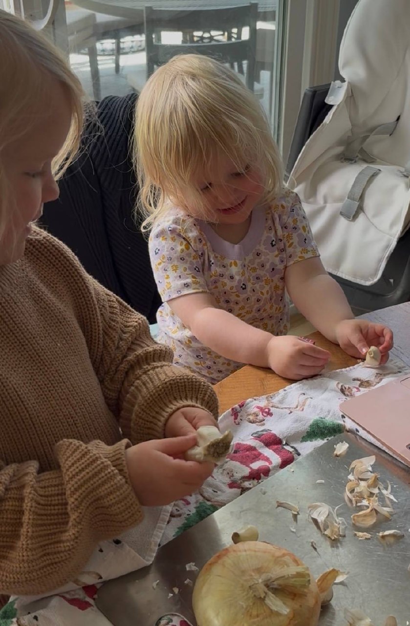 Diana's daughters peeling garlic in the kitchen